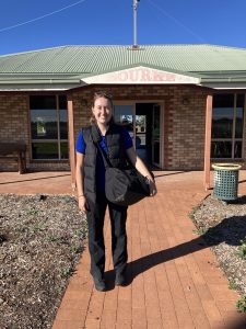 Ella standards in front of the Bourke airport building. 